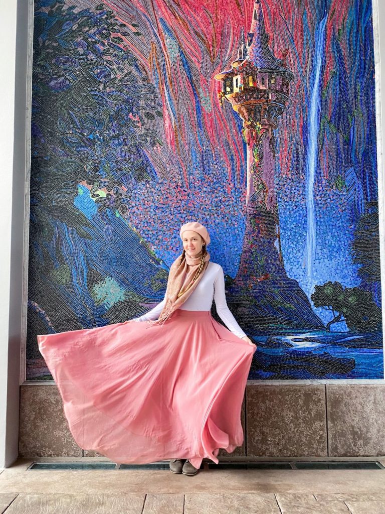 woman standing in front of the Tangled mosaic at Riviera Resort