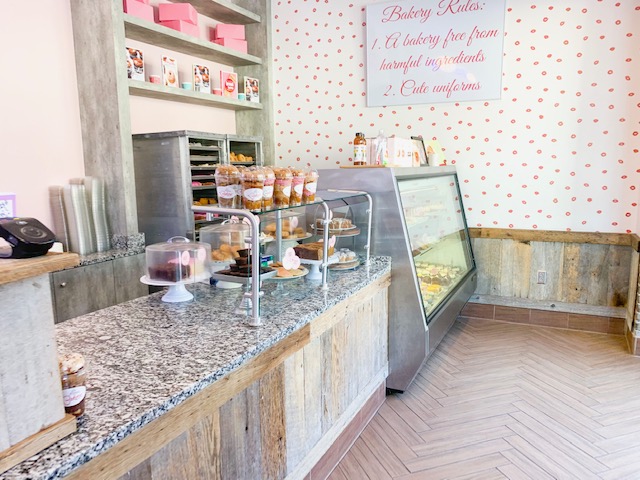 inside of Erin McKenna's bakery in Disney springs with pink walls and pastries on display