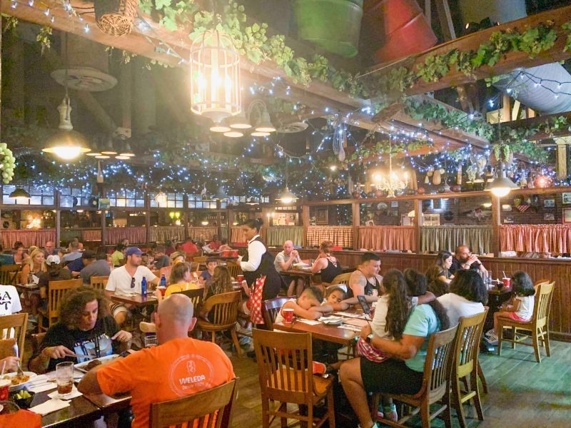 inside of Mama Melrose restaurant with trees hanging and lights