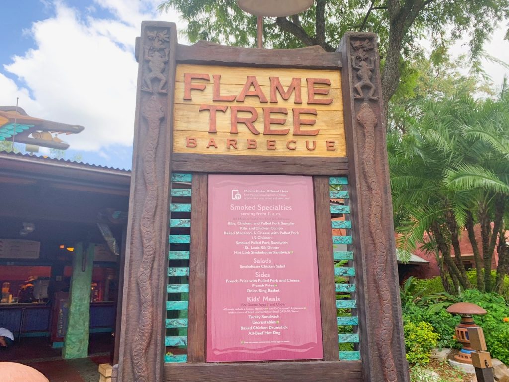 outside sign of flame tree barbecue with menu options hanging up