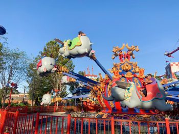 people riding Dumbo the Flying Elephant ride