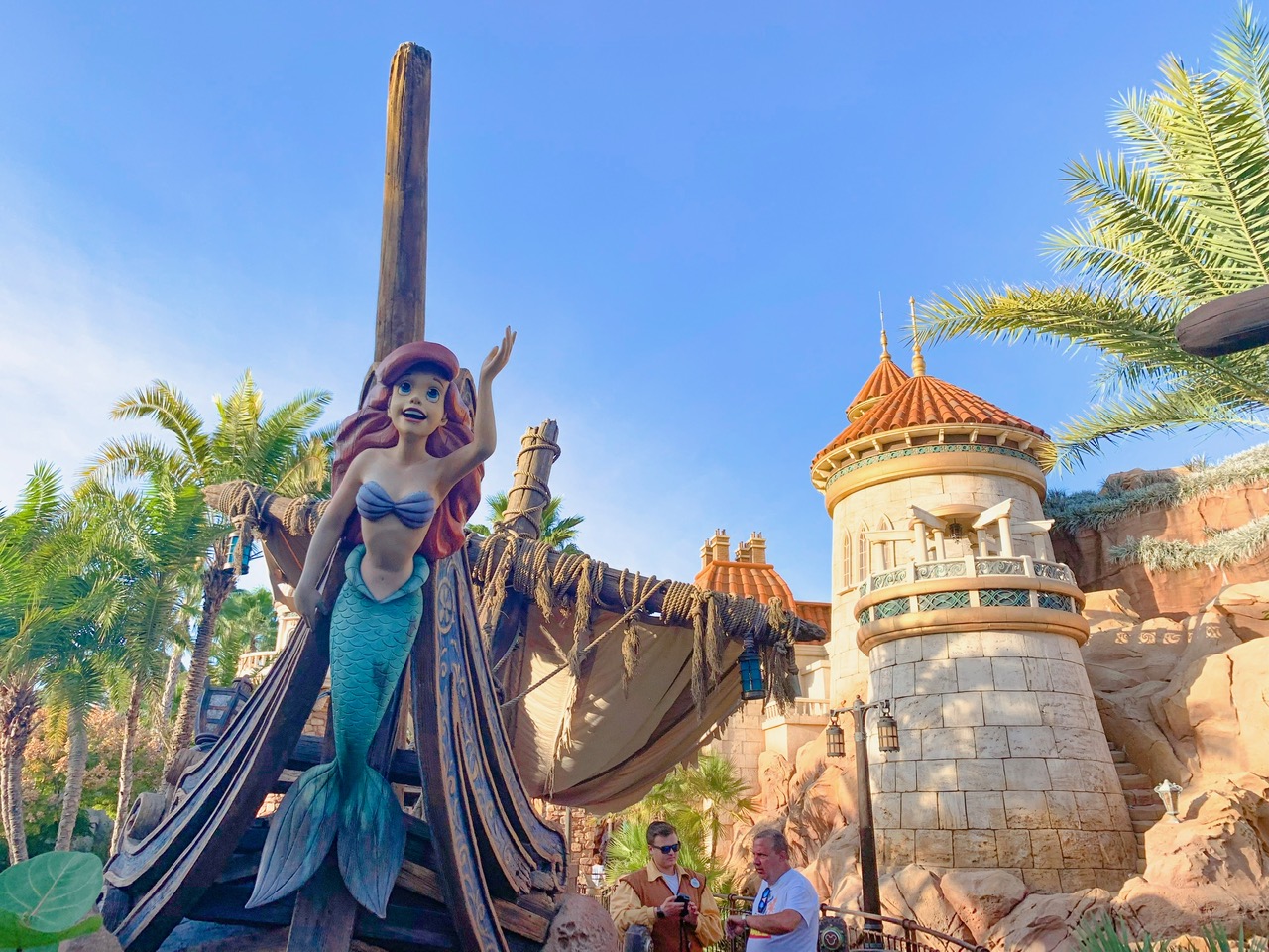 are figurine of Ariel outside the ride entrance to Journey of the Little Mermaid