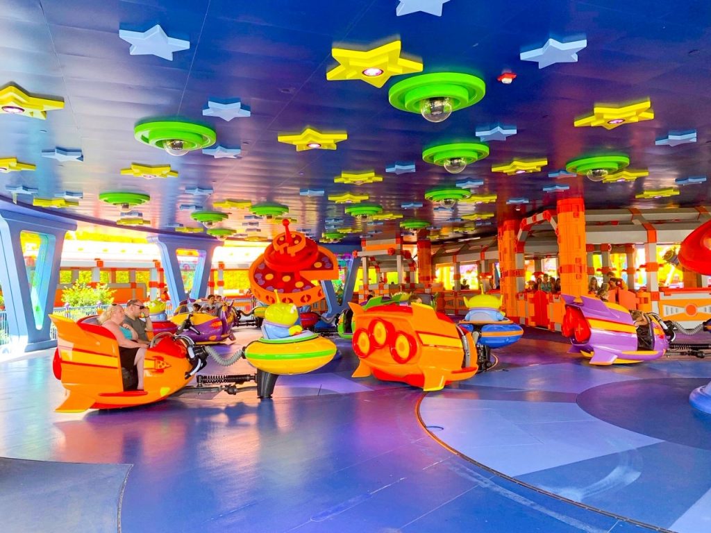 people riding alien swirling saucers