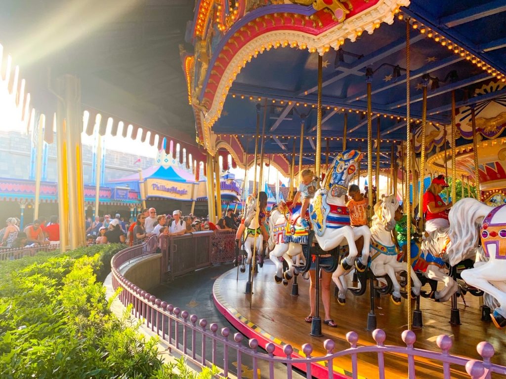 people riding prince charming regal carousel