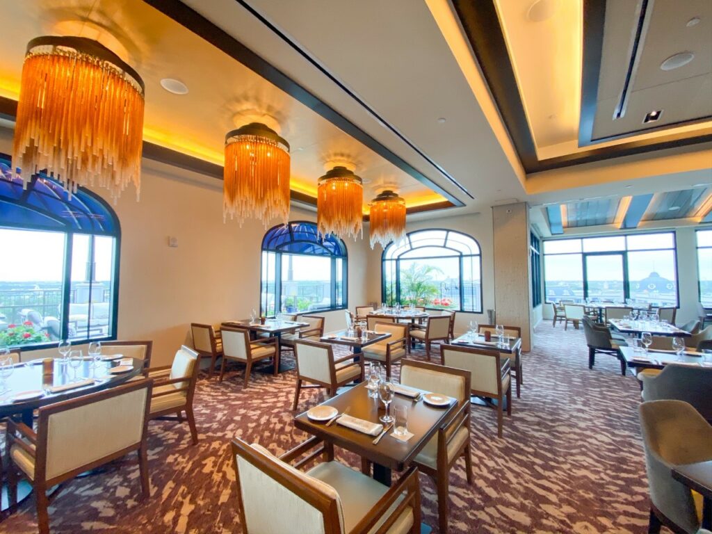 wooden chairs and restaurant tables with colorful decorative carpet and gold chandeliers rent dvc points