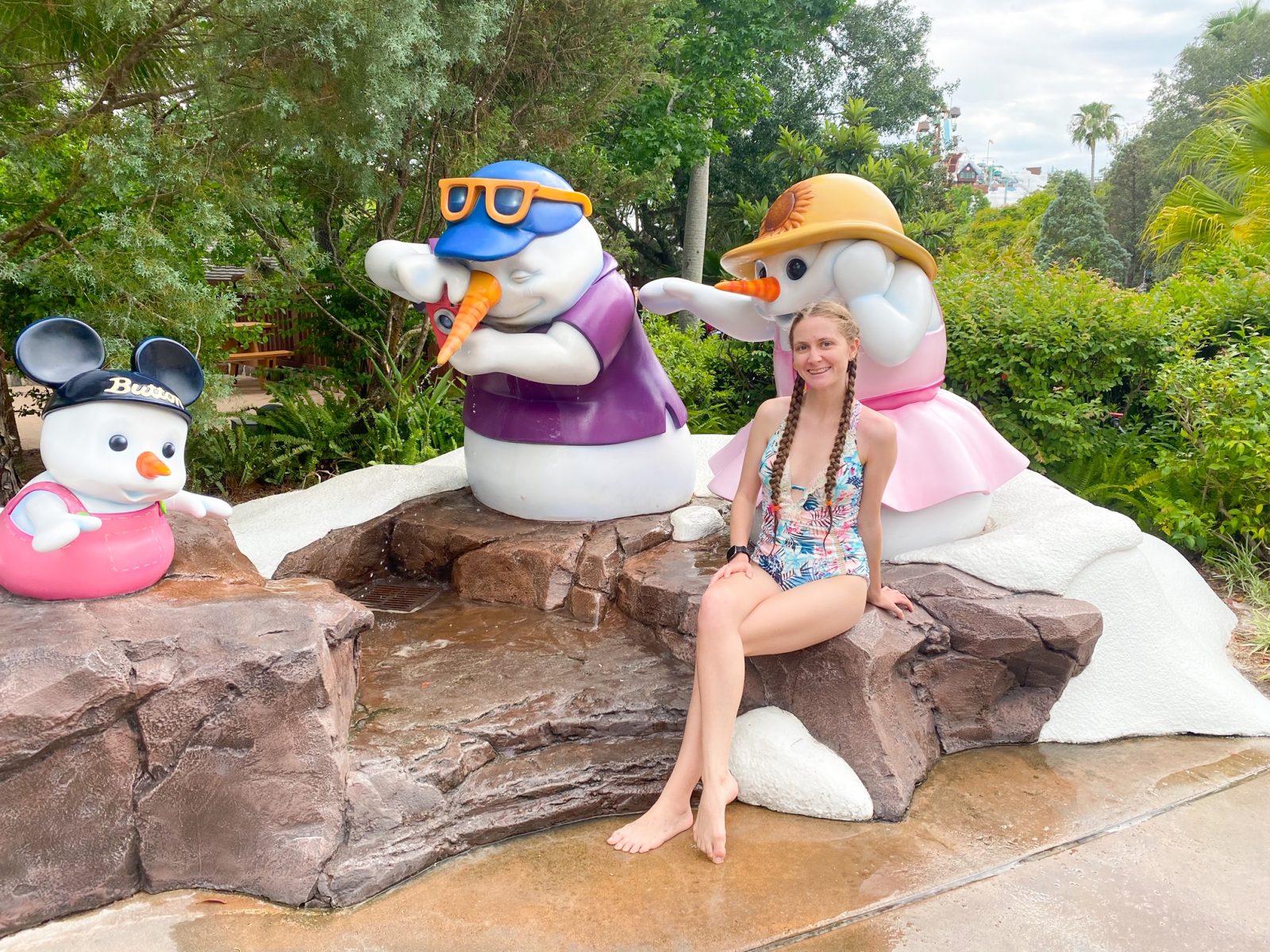 woman in bathing suit with snowpeople