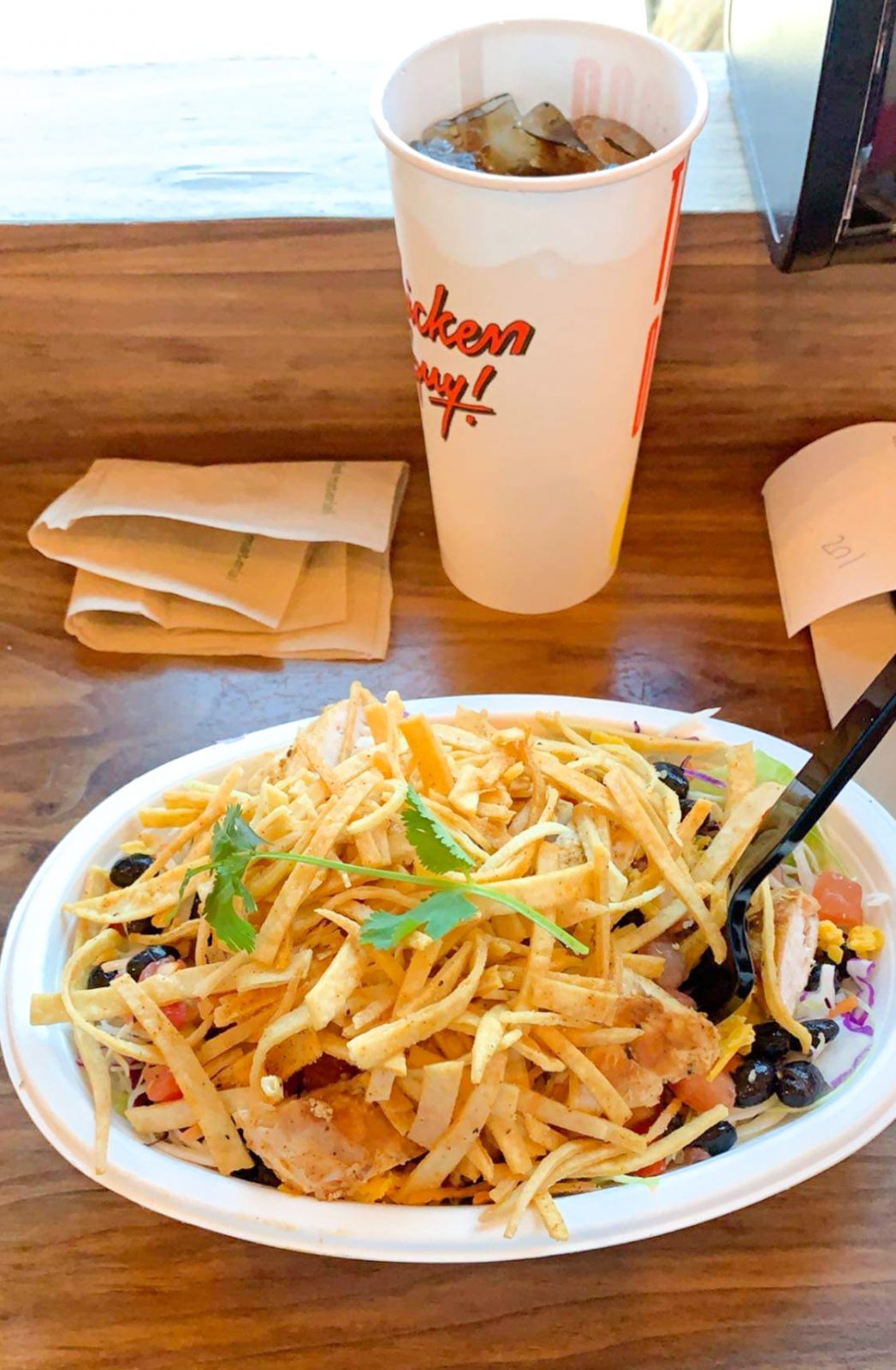 salad and soda at chicken guy restaurant 