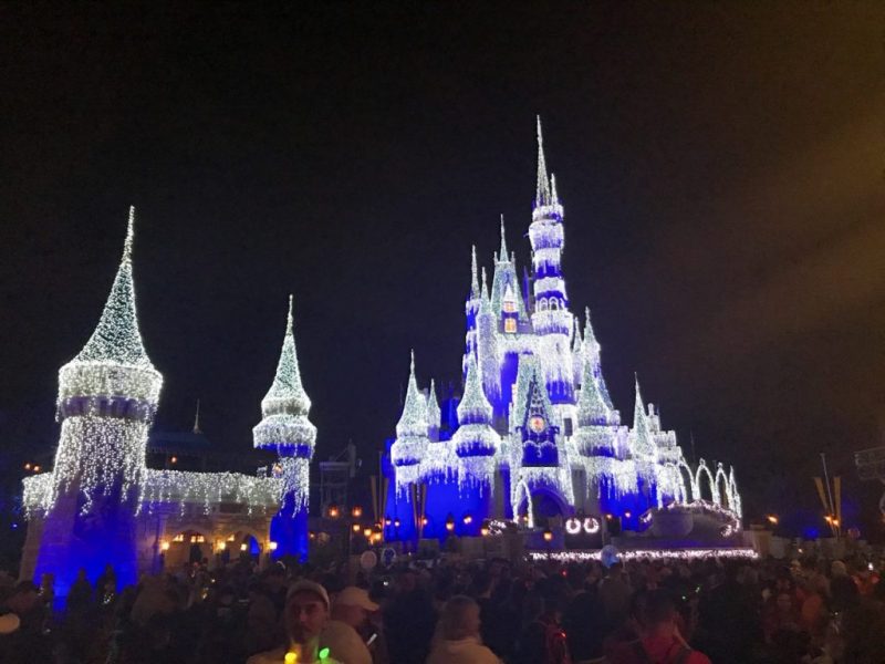 The Dream Lights on Cinderella Castle at night, one of the best displays of Christmas lights at Disney.