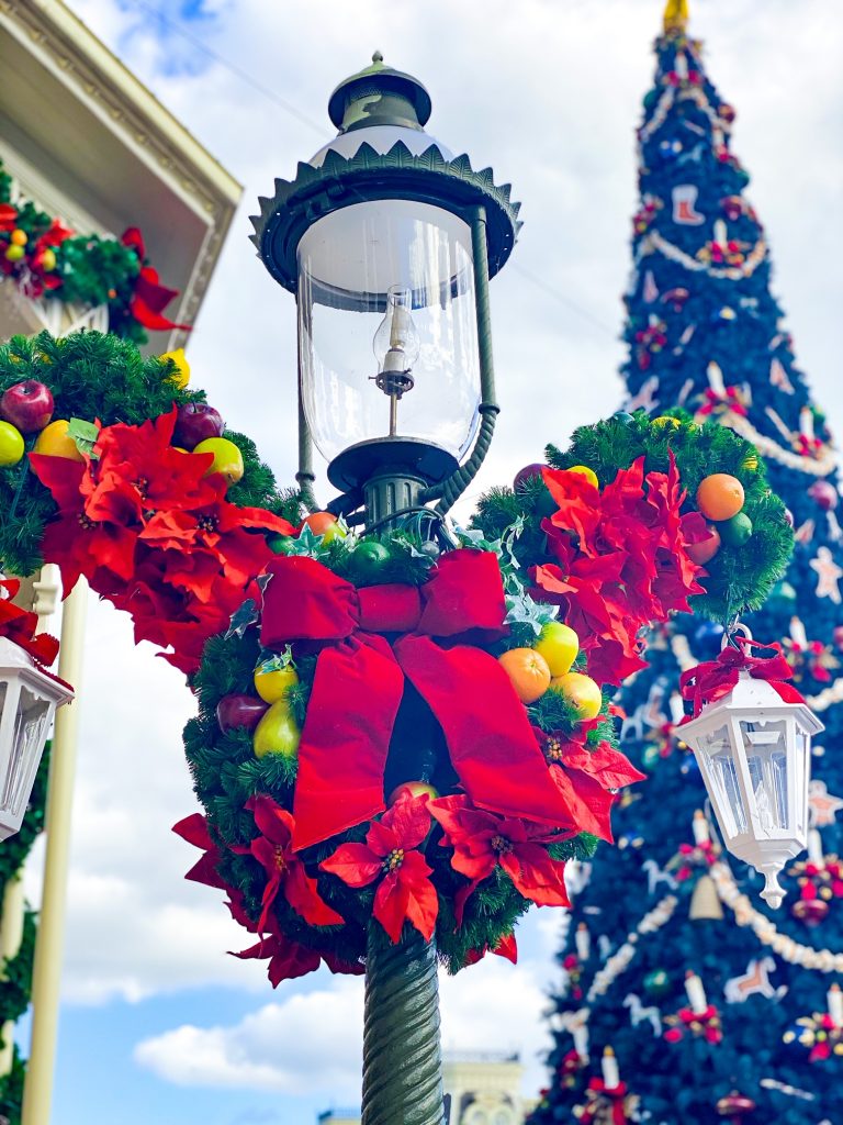 christmas lights at disney wreath and magic kingdom christmas tree