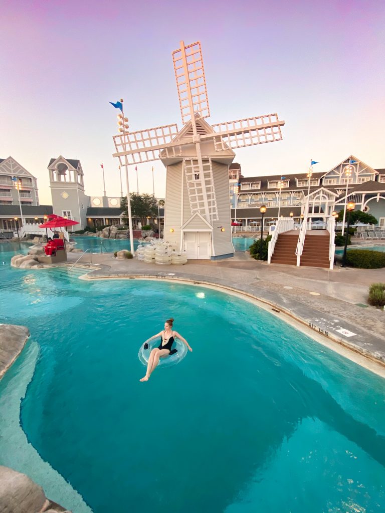 woman in lazy river in front of windmill disney pool disney rest day
