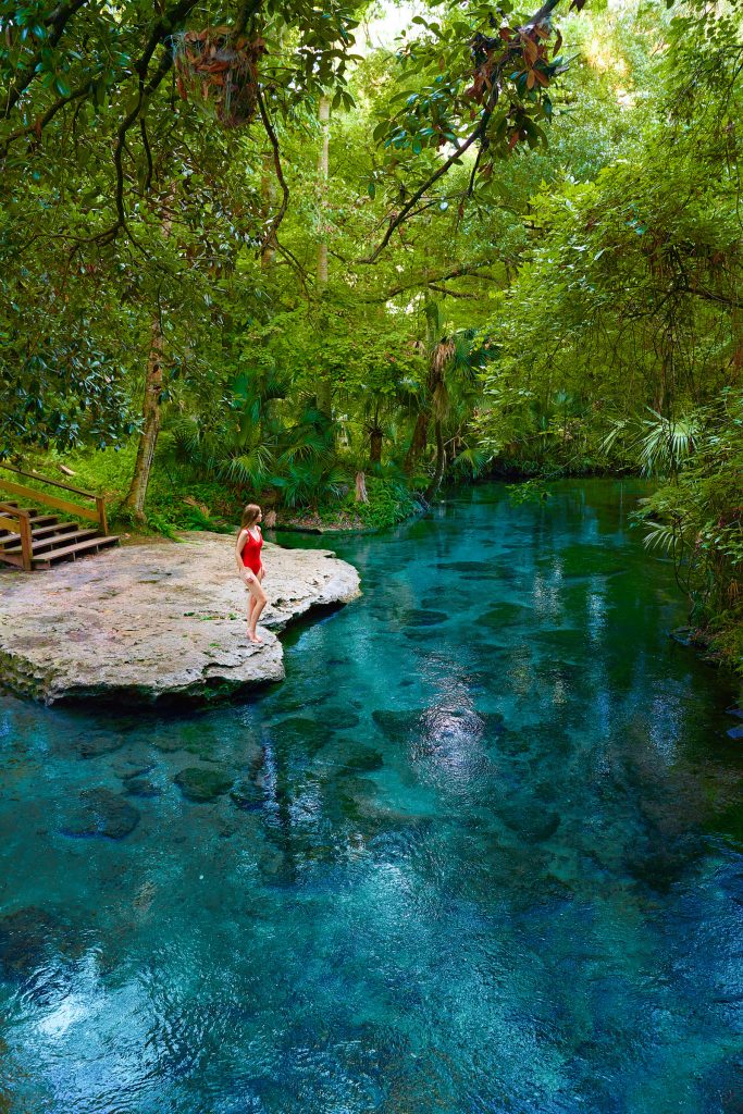 woman on rock surrounded by natural springs disney rest day