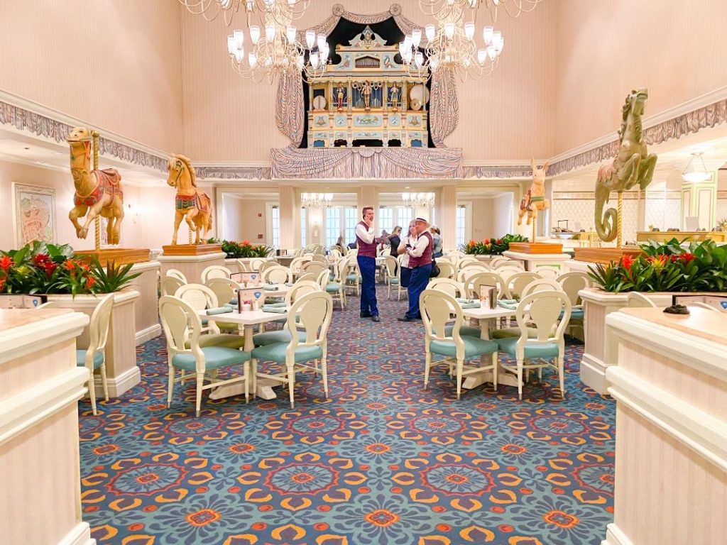 Wait staff and photographers, who are a part of Disney Memory Maker, wait in the middle of an empty restaurant, ready for a rush.