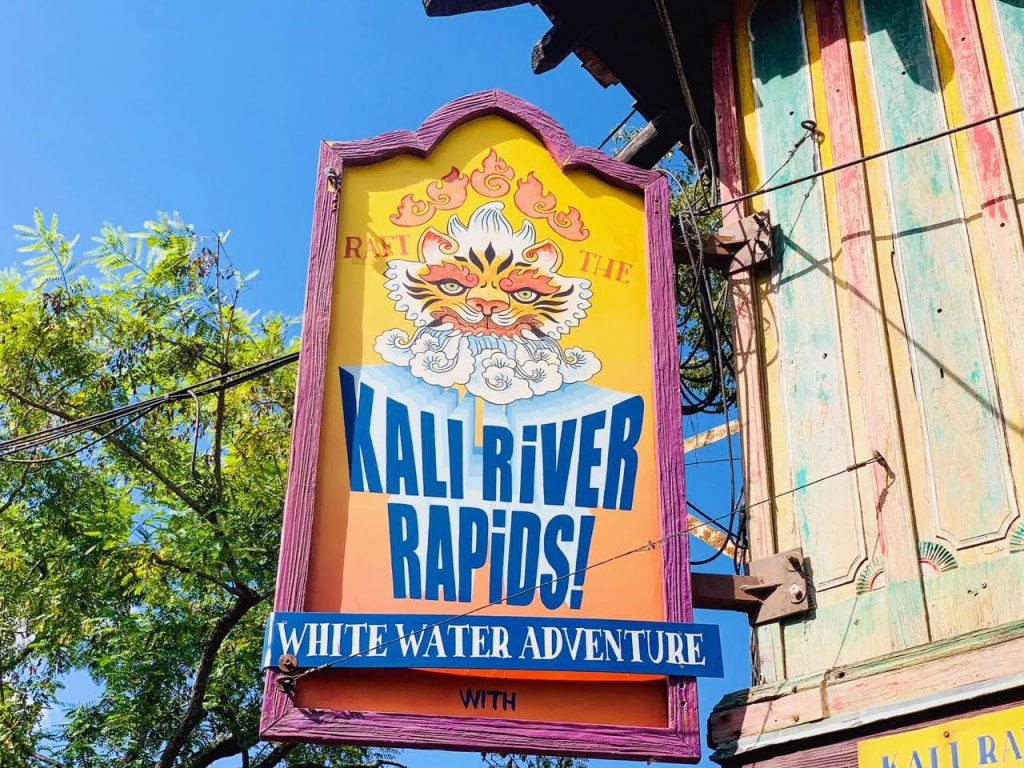 The Kali River Rapids are a white water adventure, and the sign is bold with bright colors of orange, yellow and pink. It is a warm sign considering you will get soaked! This is one of the last rides to use with Animal Kingdom Genie+.