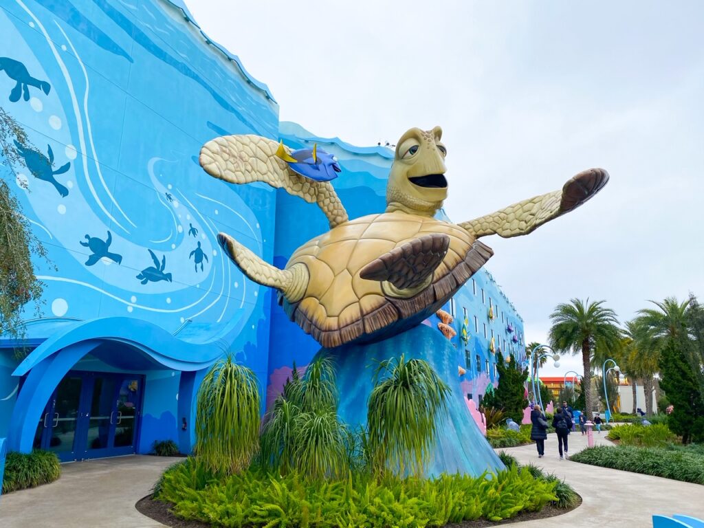 giant statue of crush the turtle outside blue building at art of animation 