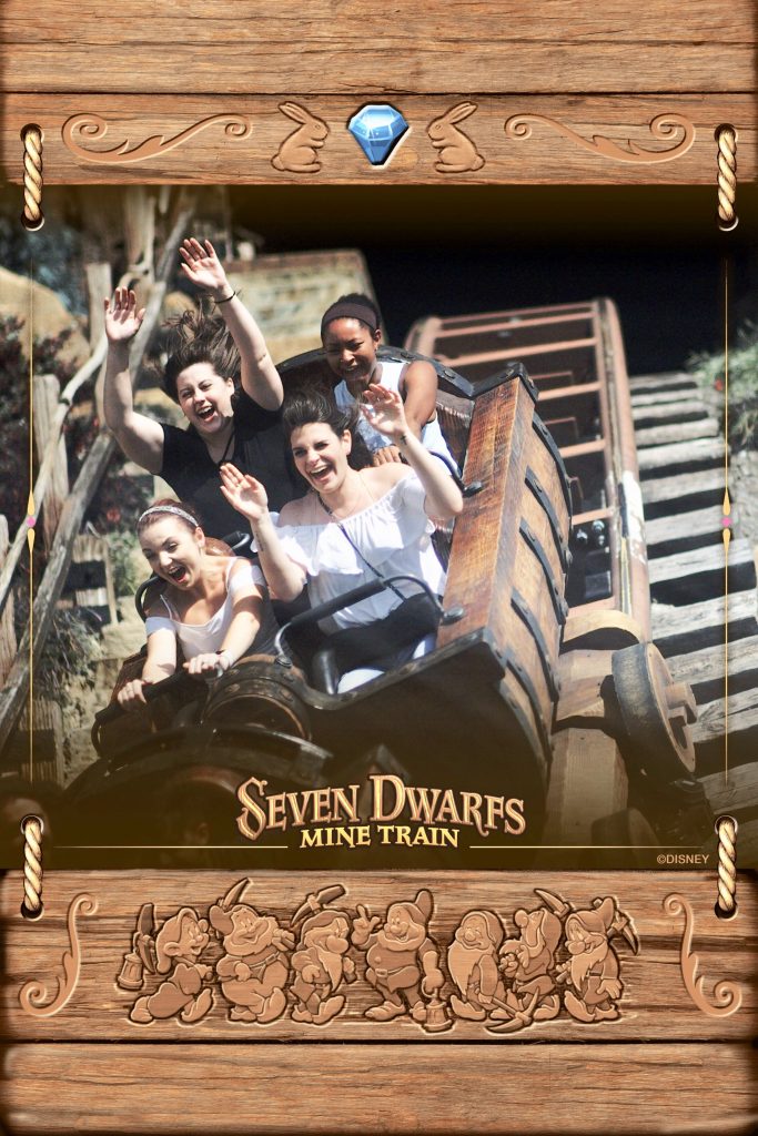 A cart full of friends on Seven Dwarfs Mine Train raise their hands and scream, which is captured on photo forever thanks to Disney Memory Maker.