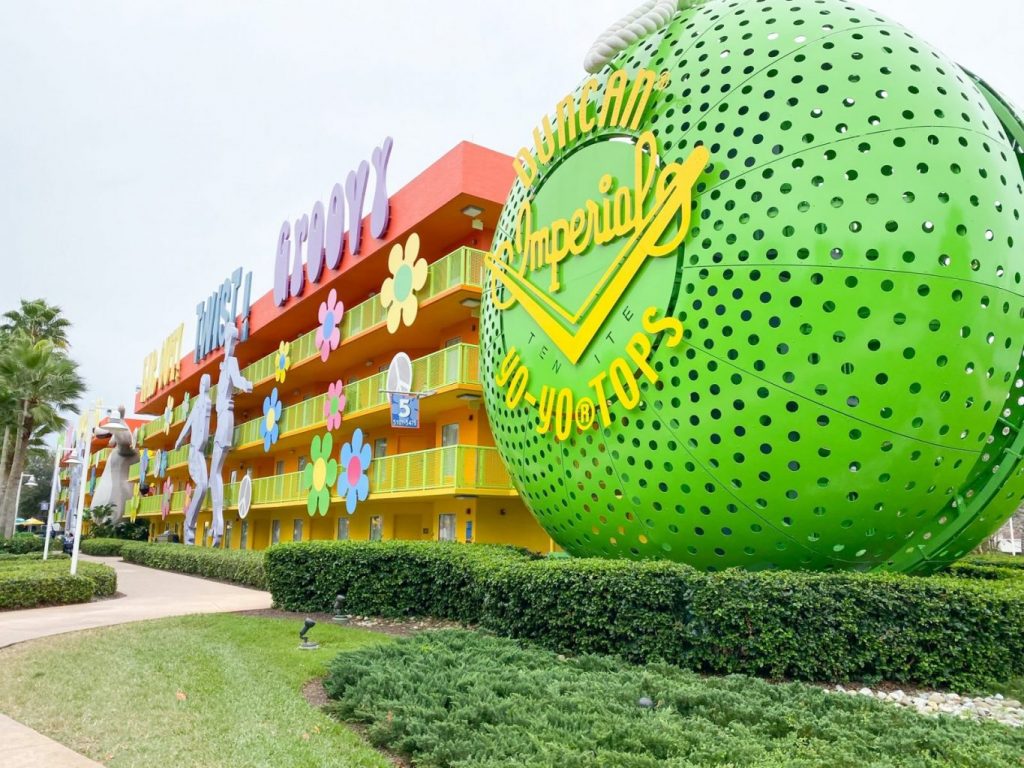 This photo is of the Pop Century Resort, which is one of the Disney Value Resorts, and this hotel is brightly colored yellow and green, featuring a giant yo-yo out front, which pays tributes to the 70s.