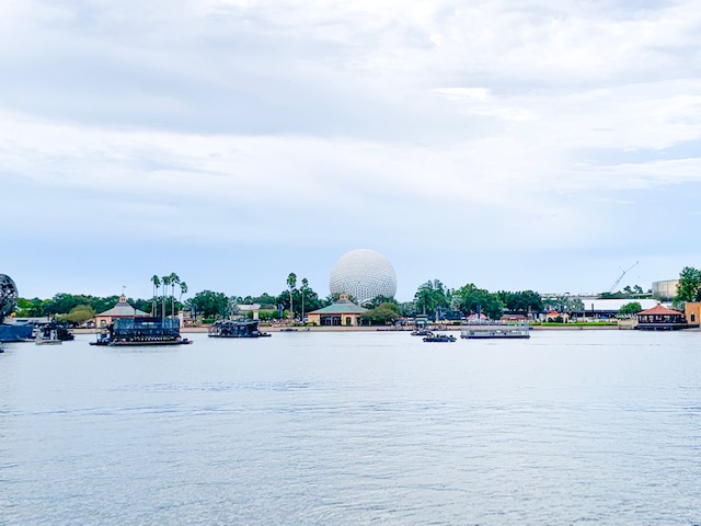 Spaceship Earth sits in the Epcot ball across the lake-- this giant white, sphere looks like a golfball and you will need Epcot Genie+ to ride it! 