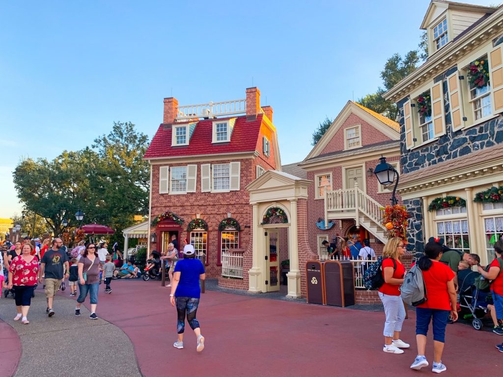 Guests walk down the main streets of Disney-- this could be you too, relaxed and stress free while using Magic Kingdom Genie+!