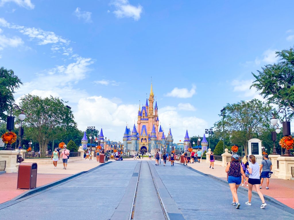 cinderella castle down main street with people walking