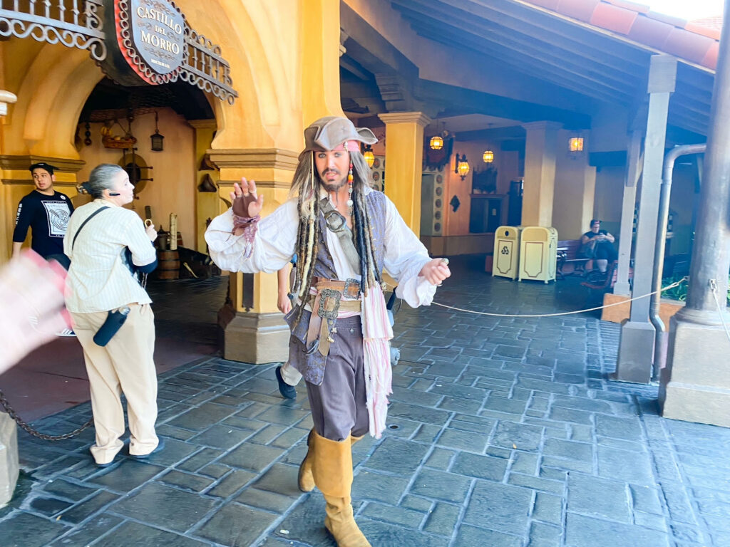 Captain Jack Sparrow outside the Pirates of the Caribbean ride, one of the best Magic Kingdom rides 