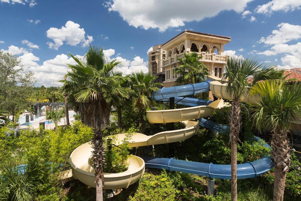 Water slide at the Four Seasons with a pavillion at the top among the trees. the article is about Orlando hotels with disney shuttles