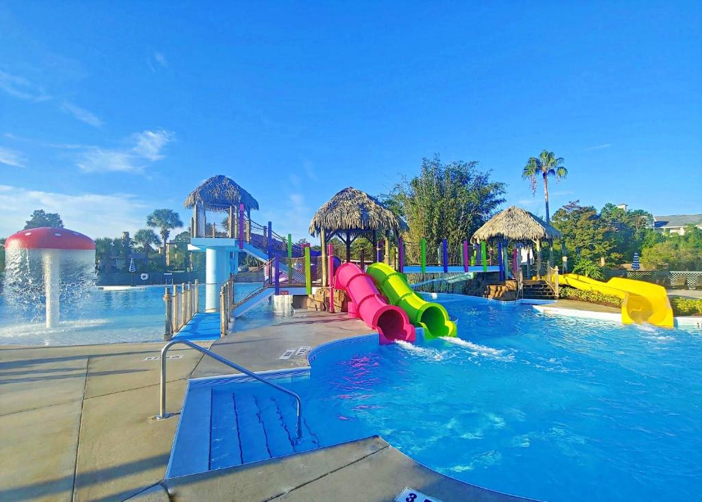 Swimming pool at the Tiki Liki showing water slides and a fountain. This article is about Orlando hotels with disney shuttles