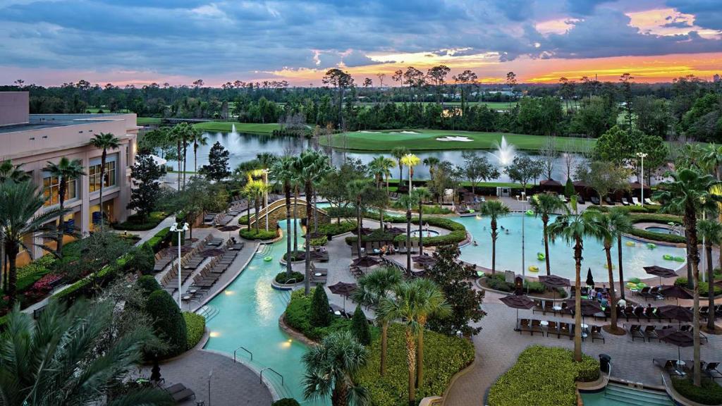 The beautiful hotel pool at Signia by Hilton Orlando wuth a lake in the background.  
