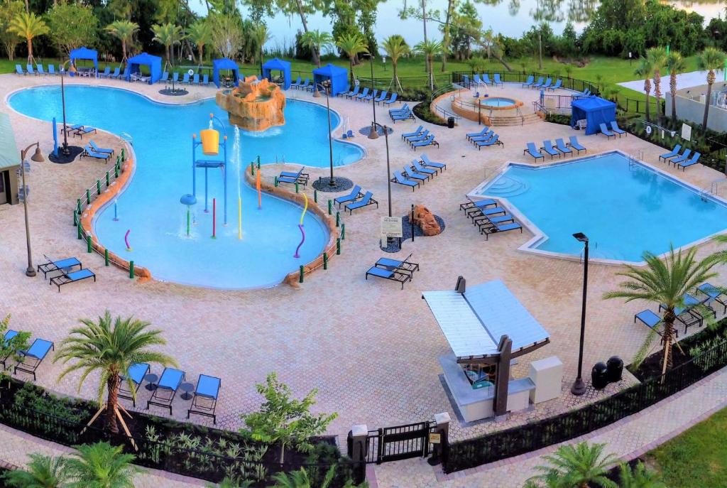 Swimming pool at hotels with two pools and a hot tub with a childrens playground. 