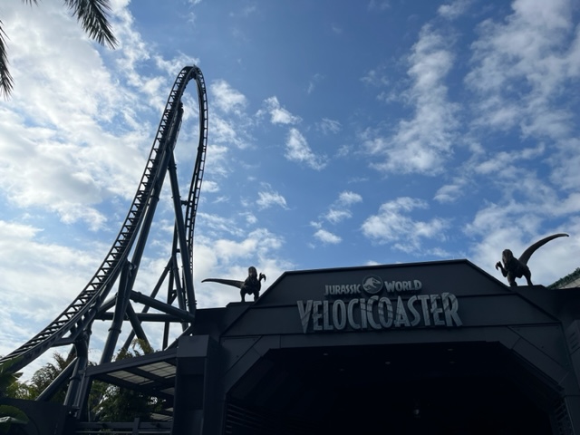 The tall, dropping, intense loop of the intense Jurassic World's Velocicoaster stretches high in the sky for all to see.