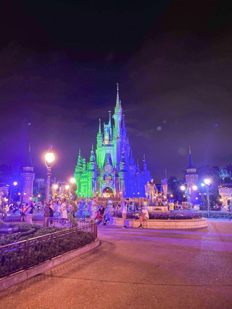 Cinderella castle at night with lights on it hidden gems at Disney
