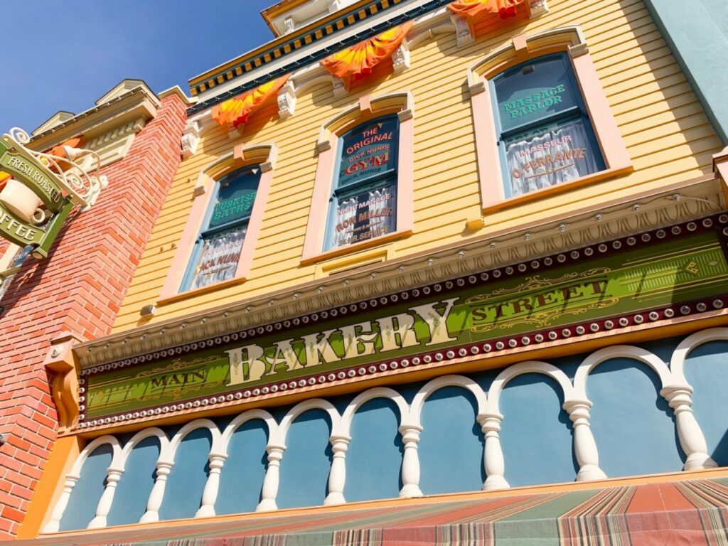 bakery sign with painted windows above it hidden gems at Disney