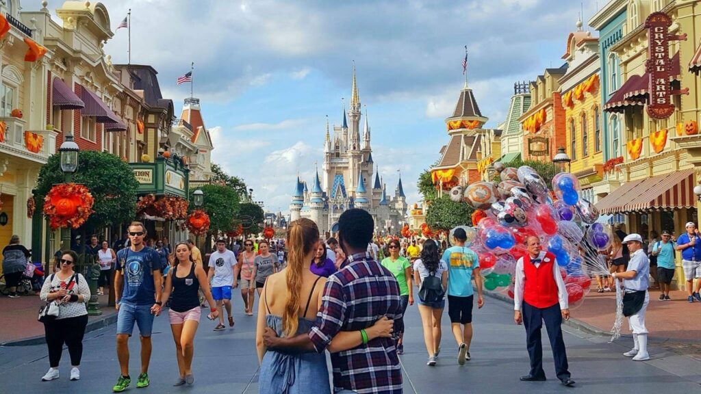 Victoria and Terrance stand in front of the Magic Kingdom's castle on Main Street, arm and arm. The castle here is different than the castle at Universal- a classic districting of Disney World vs. Universal Studios. 