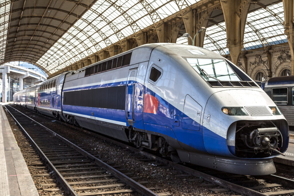 blue and grey bullet train at station Charles de Gaulle to Disneyland Paris 