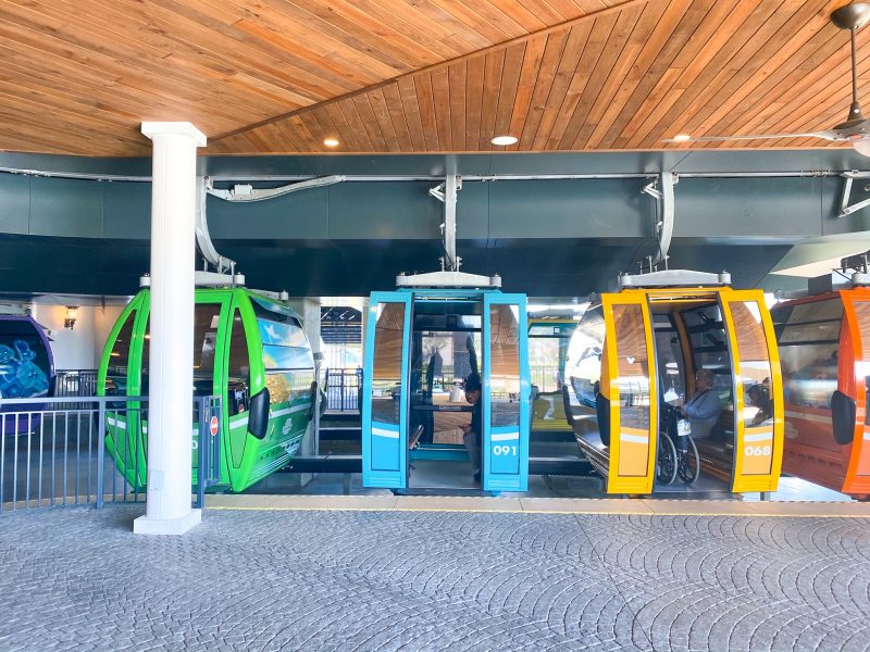 The colored Gondolas of the Skyliner line up with their doors open, ready to take you from Epcot to Hollywood Studios,