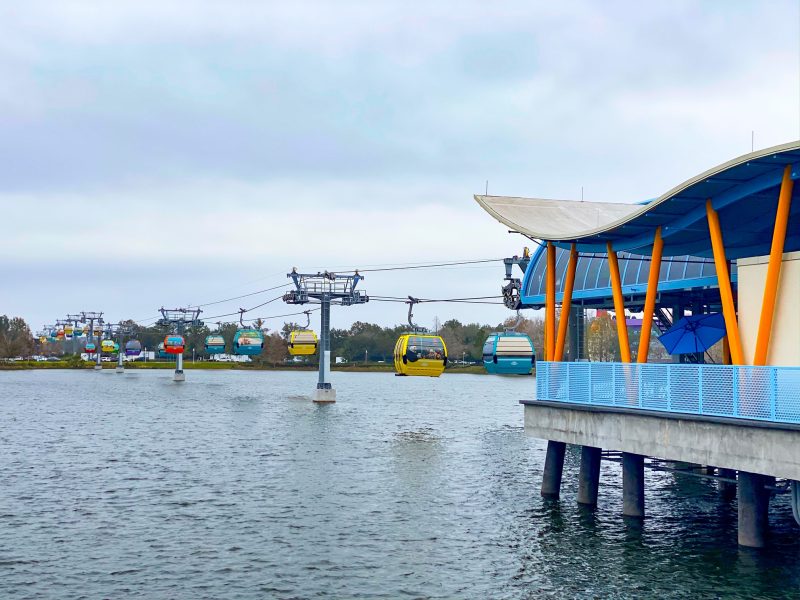 A shot of the skyliner shows the gondolas being moved across their wires above Crescent Lake.