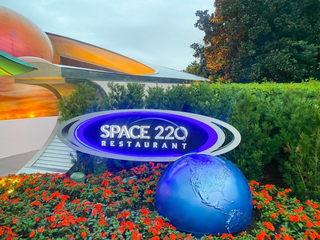 large blue sign and fake planets for space 220 restaurant Epcot for adults