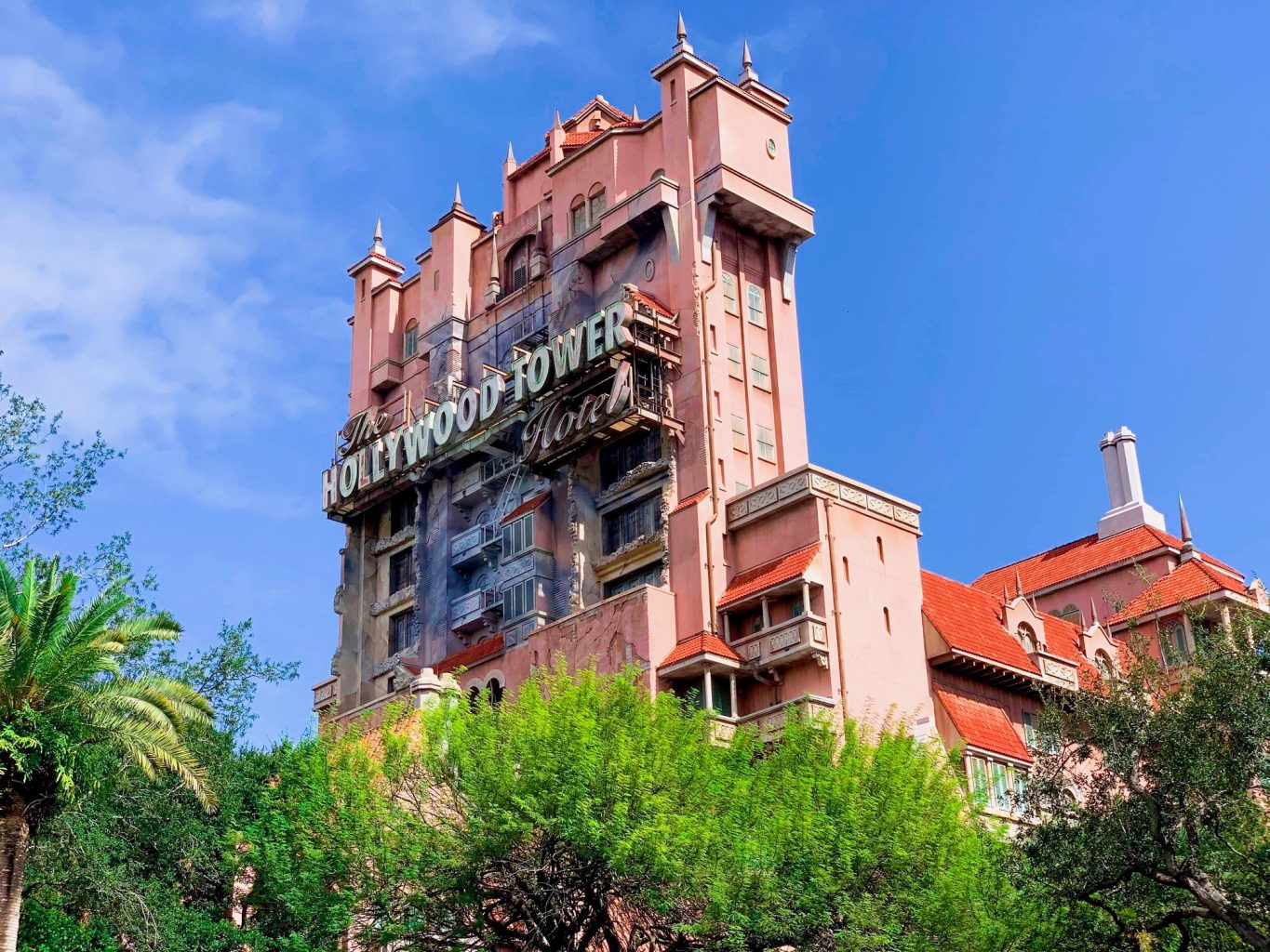 large pinkish orange hotel building with Hollywood tower hotel sign tower of terror ride Hollywood studios for adults
