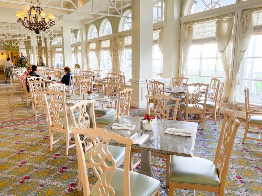 light wood and white victorian tables and chairs in restaurant 
