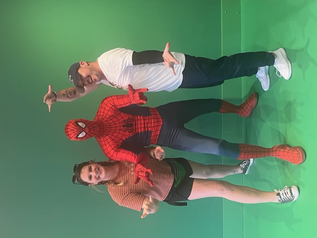 A couple poses with SpiderMan, enjoying the meet and greet after they knew which mistakes to avoid at Universal Orlando and had time for this interaction. 
