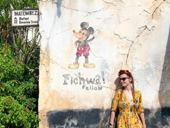 woman standing in front of mickey mural at animal kingdom