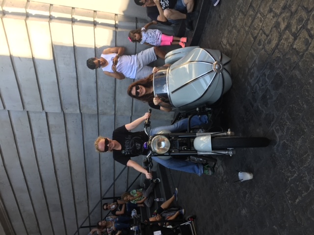 Two girls sit in Hagrid's motorbike and sidecar outside of Gringotts for a fun-filled day in which they saved tons of money! 