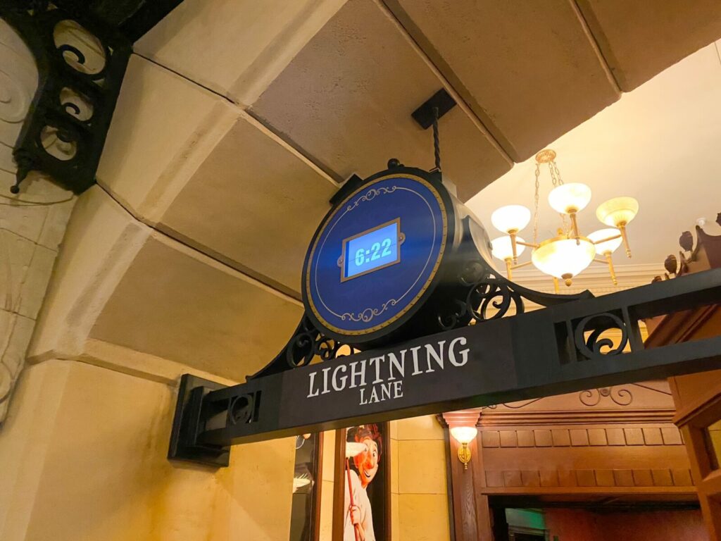 sign with time and "lightning lane" written on it disney world in 2025 changes 