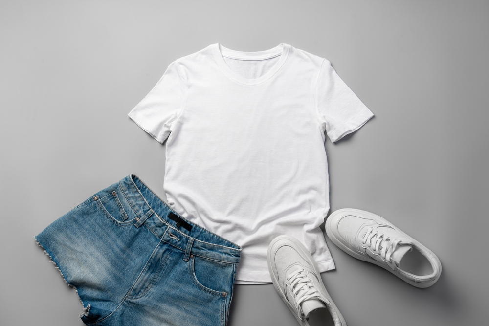 white tee with jean shorts and white sneakers flatlay