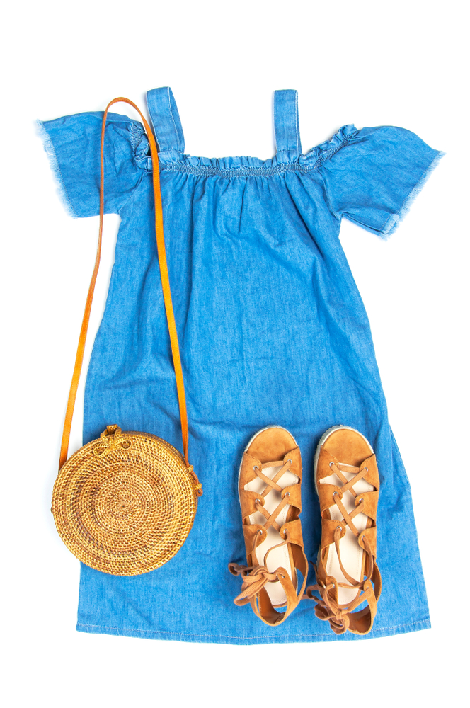 blue denim sundress with brown sandals and straw purse flatlay disney outfit ideas for mom 