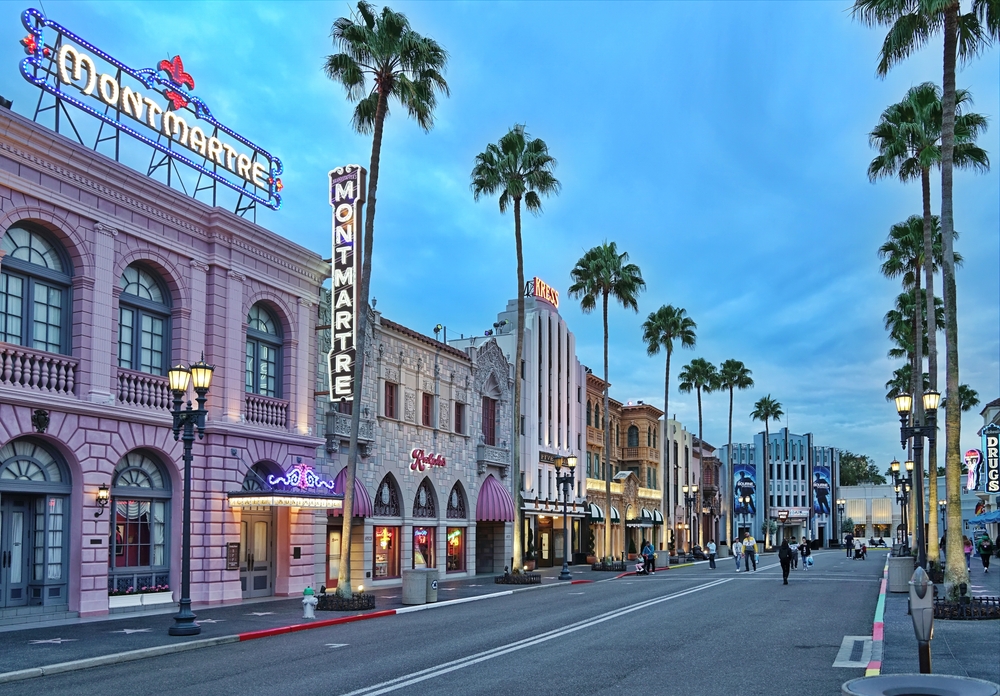 At dusk, the entrance street of Hollywood studios is fairly empty, the lights bright in the darkening sky, palm trees tall: knowing Things People Forget When Packing for Disney World  will help prepare you for this park. 