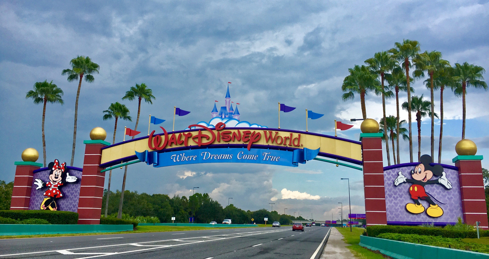 The Walt Disney World Sign welcomes guests with Mickey and Minnie on the sides: knowing Things People Forget When Packing for Disney World will help prepare for this magical trip!