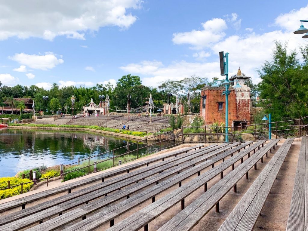 lots of wooden bench seating and green trees disney world picnic spots