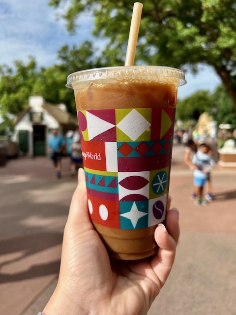 hand holding decorative iced coffee cup from Disney world