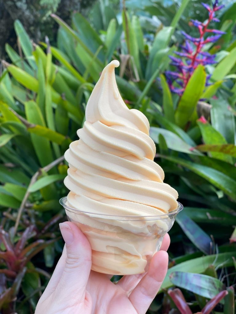 hand holding frozen pineapple ice cream treat