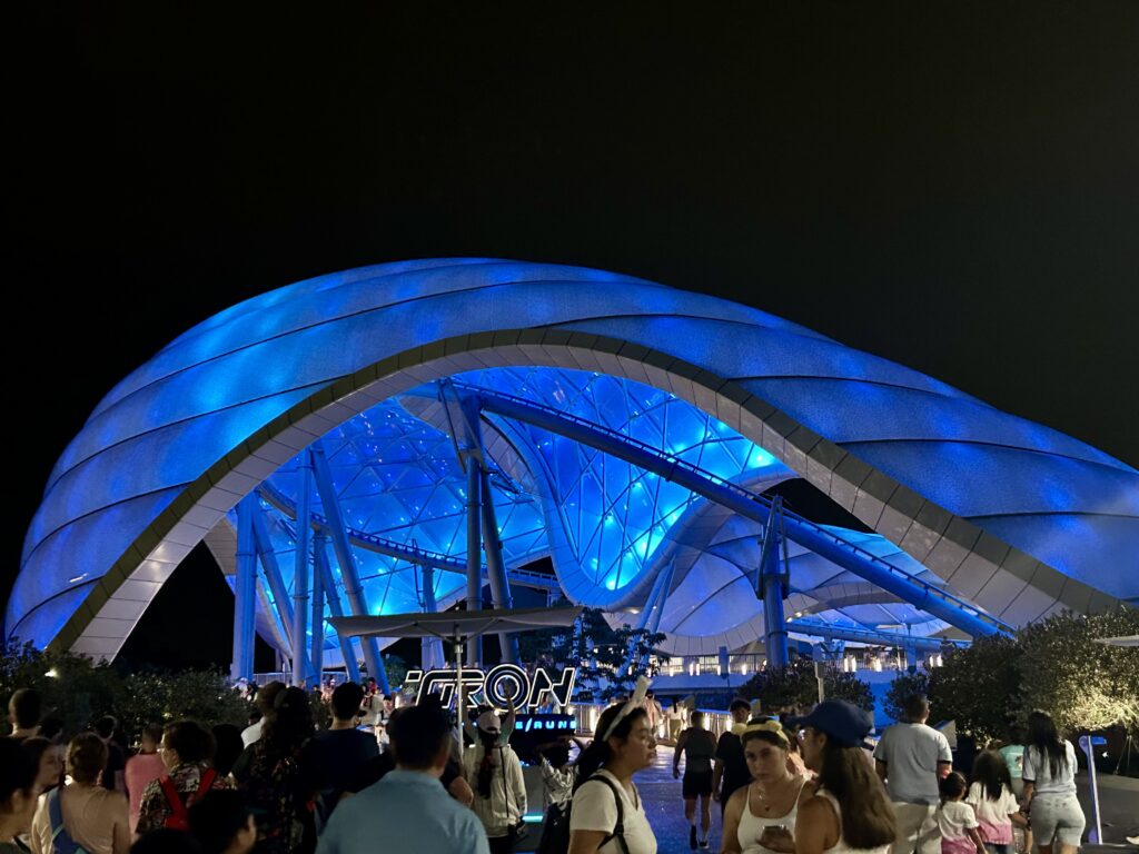large blue lit up canopy over people walking iron ride for 2 days at disney